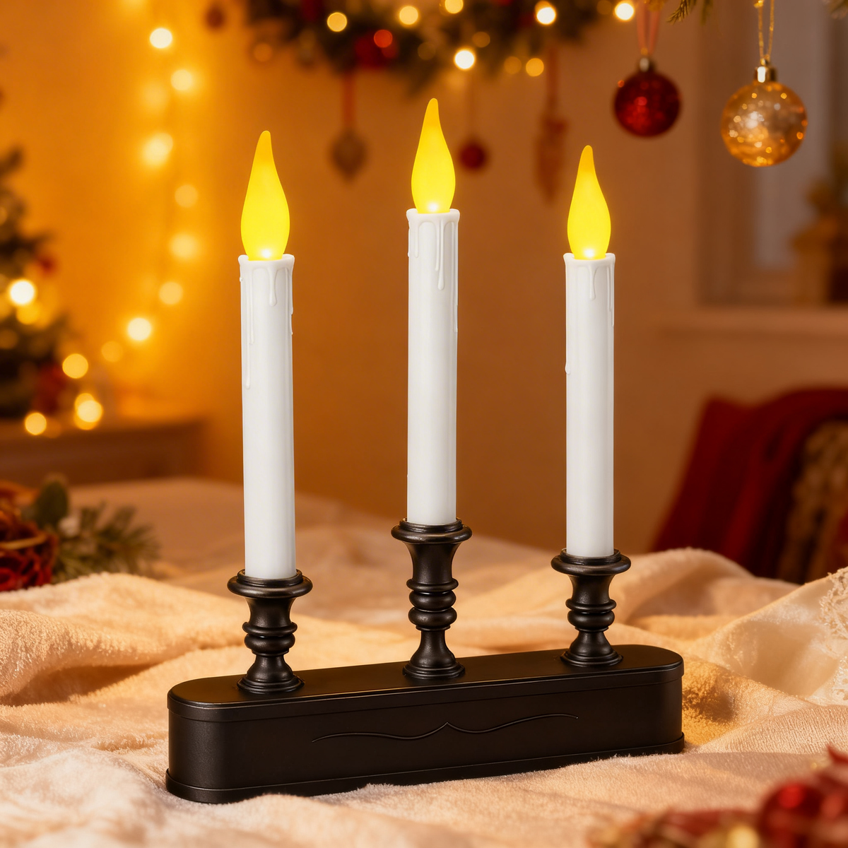 Candelabra, black base, three white flickering taper LED candles, placed on fabric surface in festive room